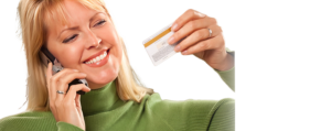Woman on Phone Holding New Credit Card After Credit Score Repair in Brooklyn, Farmingdale, Garden City, Medford, Middle Island, NY